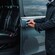 A private driver opening the door of a luxury minivan